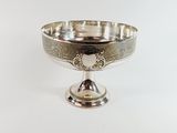 an antique silver plate with a heart on it on a white background