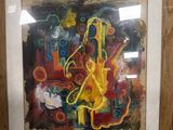 painting in a frame on a table in a room