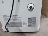 a white refrigerator sitting on the floor next to a cardboard box