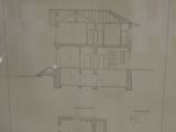 a drawing of a house on display in a glass case