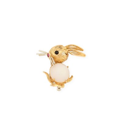 an image of a broochle of a rabbit with a ball in its mouth