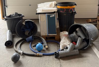 a lot of garbage that is on the ground next to a garage door