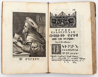 an old book with a picture of a man sitting at a table