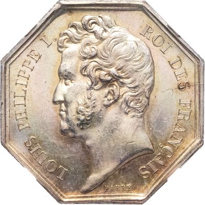 une image représentant une pièce d'argent sur laquelle figure le portrait d'un homme