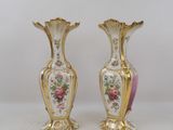 two vases that are sitting on a table