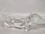 clear glass dog figurine sitting on a white surface