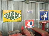 many old tractors in a garage with signs on the wall