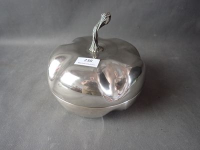 a silver apple with a tag on it on a table