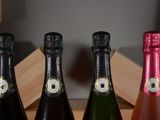 four bottles of wine are lined up in a row on a table