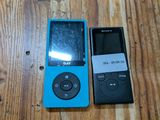 deux lecteurs MP3 posés sur une table en bois