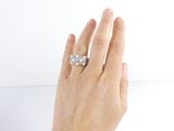 a woman ' s hand that is holding a diamond ring