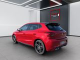the rear end of a red car parked in a garage