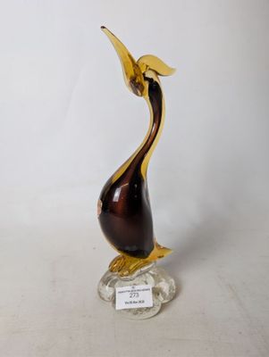 a glass sculpture of a bird on a clear base
