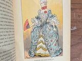 an open book with a picture of a lady in a blue dress