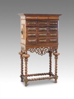 an old wooden cabinet with drawers and a drawer on top of it