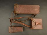 three leather luggage tags are laid out on a gray surface