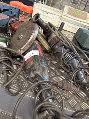 a pile of tools sitting on top of a metal table