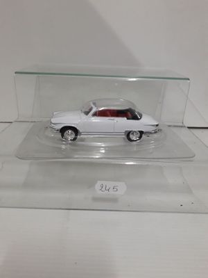 a white car in a clear display case on a table