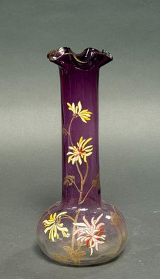 a purple vase with yellow and white flowers on it
