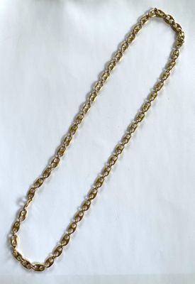 a close up of a gold chain on a white background