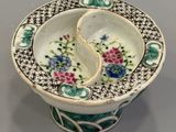 a small bowl that has a broken piece in it