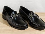 men ' s black leather loafers with chain detail on the sole