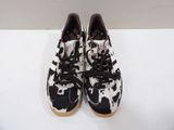 black and white cow print sneakers on a white surface