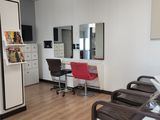 a picture of a salon room with chairs and tables