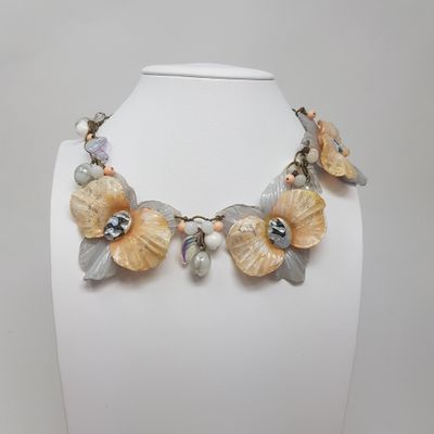 un mannequin blanc orné de fleurs et de perles