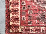 a close up of a red rug with fringes on it