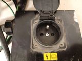 a close up of a black electrical outlet on a table