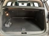the back of a car with the trunk open and a bag in the trunk
