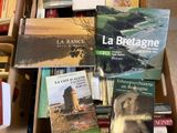 many books that are sitting in a box on the floor
