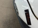 a sticker on the hood of a white car