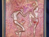 sculpture of a man and a woman on a wooden easel