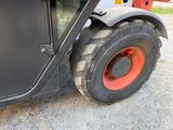 a tractor that is parked on the side of the road