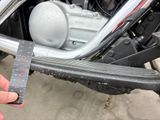 a person that is holding a piece of paper in front of a motorcycle