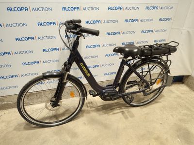 a bicycle that is parked in front of a wall