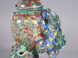 a vase with a dragon on it and a dragon on the lid