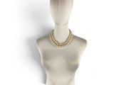 beige beaded necklace on mannequin head on white background
