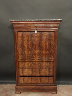 an antique walnut chest of drawers with marble top