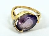 an image of a ring with a purple stone surrounded by diamonds
