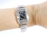 a person wearing a silver watch on their wrist