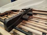 a gun that is laying on top of a bed