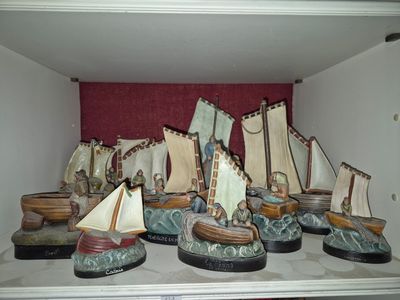 a shelf that has a bunch of small boats on it