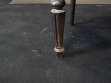 a black table with a wooden top and a metal base