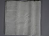 a close up of a piece of white paper with a small embroidered design on it