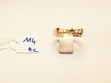 a ring with a diamond on it and a tag with a name on it