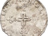 a close up of a coin with a cross on it