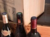 several bottles of wine are lined up in a wooden box